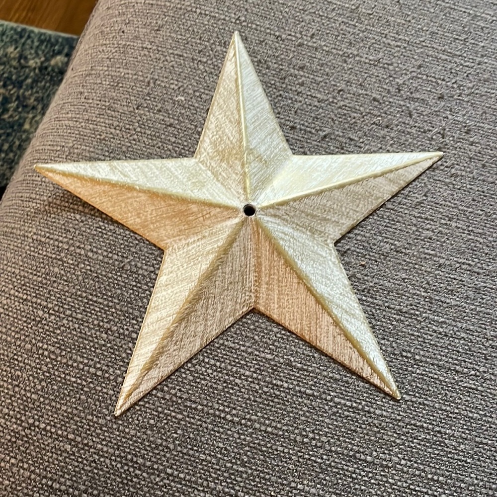 White star with some gold detailing on the front